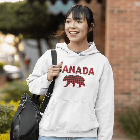 Meet the Plaid & Proud Hoodie, featuring a rugged red & black plaid bear alongside "Canada" in matching plaid lettering—because nothing says “True North strong” like a bear rocking Canadian flannel.