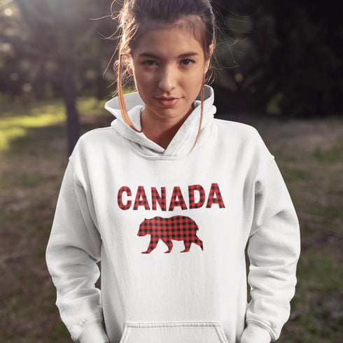 Meet the Plaid & Proud Hoodie, featuring a rugged red & black plaid bear alongside "Canada" in matching plaid lettering—because nothing says “True North strong” like a bear rocking Canadian flannel.