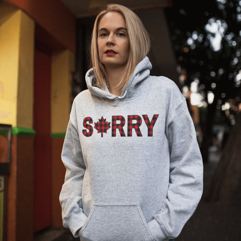 Say “Sorry” the Canadian way with our Sorry, Eh? Hoodie! Featuring "Sorry" in red and black plaid with a maple leaf as the “O,” this hoodie is apologetically Canadian in every way.