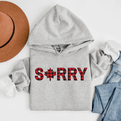 Say “Sorry” the Canadian way with our Sorry, Eh? Hoodie! Featuring "Sorry" in red and black plaid with a maple leaf as the “O,” this hoodie is apologetically Canadian in every way.