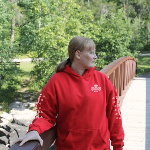 Premium Canada hoodie featuring Indigenous-inspired maple leaf art and Canada sleeve print. Cozy unisex sweatshirt perfect for travel, gifts, and everyday wear.