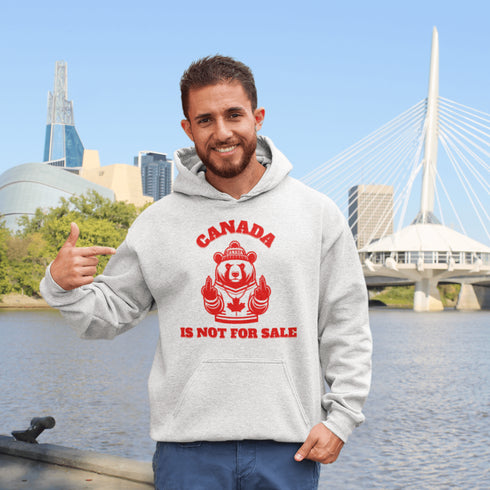 Show off your unapologetic Canadian pride with our bold and rebellious "Canada Is Not For Sale" hoodie. Featuring a feisty bear rocking a Canada shirt and hat.
