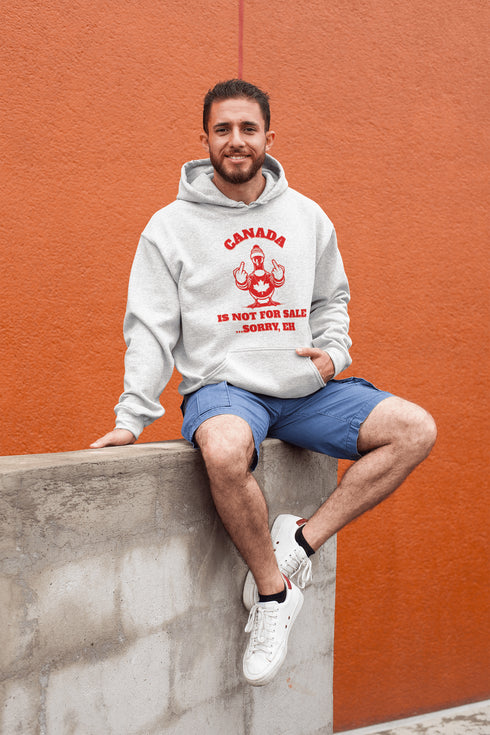 Make a bold statement with our "Canada Is Not For Sale" hoodie, featuring a fearless Canadian goose rocking a Canada shirt and hat