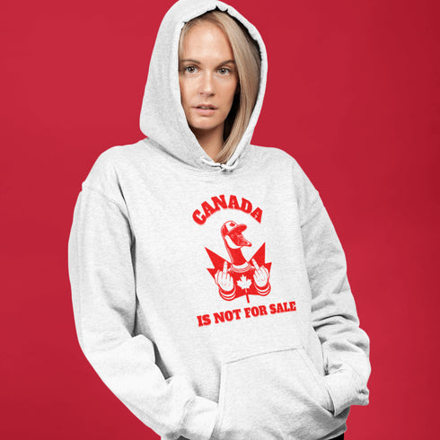 Show off your unapologetic Canadian pride with our bold and rebellious "Canada Is Not For Sale" hoodie. Featuring a feisty goose rocking a Canada shirt and hat