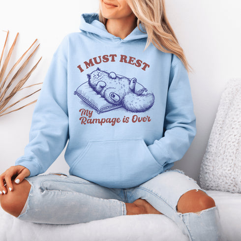 Behold the ultimate post-chaos attire: a chill cat sprawled on a pillow, announcing to the world, "I must rest, my rampage is over."