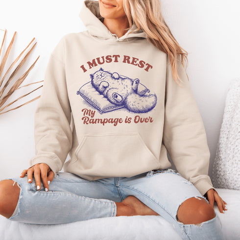 Behold the ultimate post-chaos attire: a chill cat sprawled on a pillow, announcing to the world, "I must rest, my rampage is over."