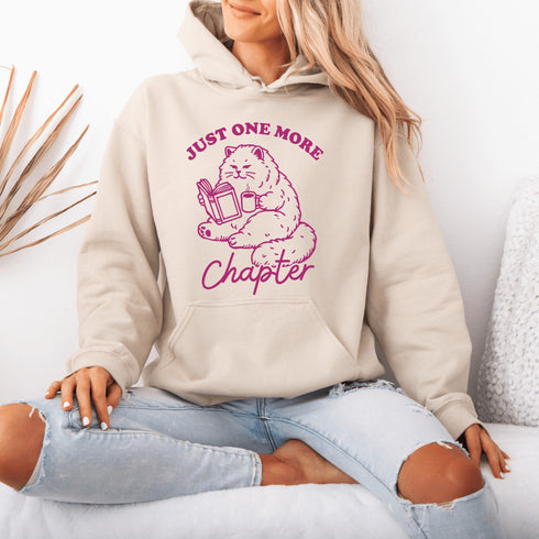 This hoodie features a studious cat perched with a book, proving that even felines can't resist the pull of "just one more chapter."