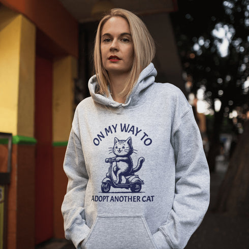 Featuring a playful illustration of a determined cat riding a scooter, this hoodie is the purr-fect way to announce your cat-loving intentions to the world.