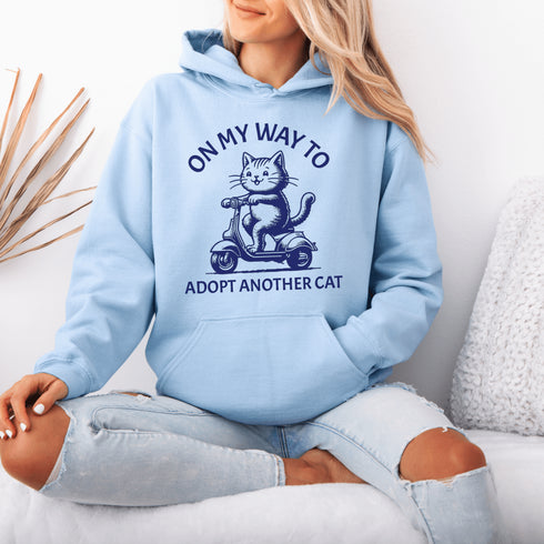 Featuring a playful illustration of a determined cat riding a scooter, this hoodie is the purr-fect way to announce your cat-loving intentions to the world.