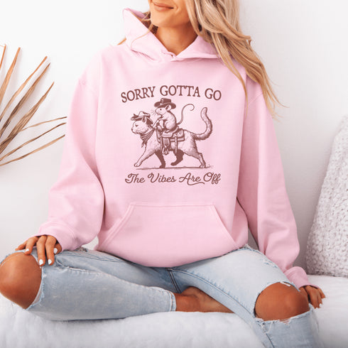 Take your fashion game to the wild frontier with our quirky and bold hoodie featuring a mouse riding a cat like a cowboy—both decked out in classic cowboy hats.