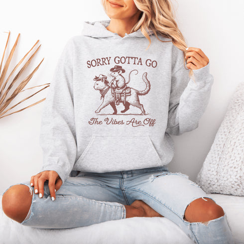 Take your fashion game to the wild frontier with our quirky and bold hoodie featuring a mouse riding a cat like a cowboy—both decked out in classic cowboy hats.