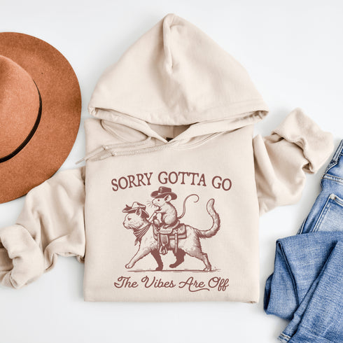 Take your fashion game to the wild frontier with our quirky and bold hoodie featuring a mouse riding a cat like a cowboy—both decked out in classic cowboy hats.
