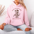 This hoodie is purr-fect for anyone who loves cats, chaos, and a healthy dose of cowboy attitude. Featuring a grumpy cat in a cowboy hat, pointing a tiny pistol