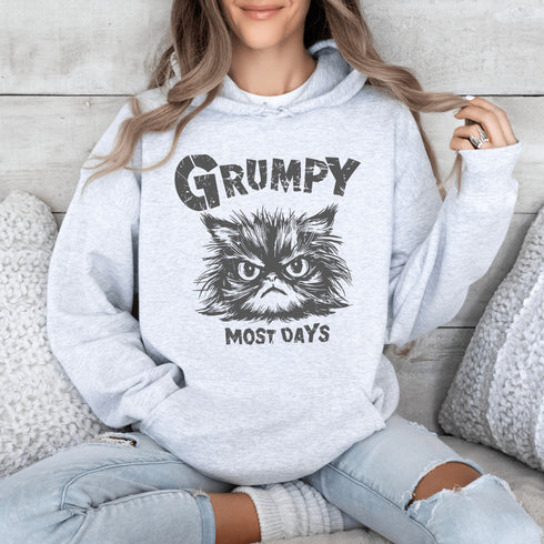 Introducing the "Grumpy Most Days" Hoodie—because let's face it, some days just require a permanent scowl. Featuring the grumpiest cat you’ve ever seen, this hoodie is perfect for those days when coffee, sunshine, or people just aren't cutting it.