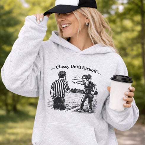 Funny soccer hoodie with “Classy Until Kickoff” text and illustration of woman yelling at referee on soccer field
