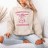This hoodie features a wildly unpredictable cat dangling upside-down from a ceiling fan, perfectly paired with the slogan "Completely Unhinged."