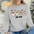 Featuring a posse of cartoon ghosts decked out in cowboy hats, boots, and even a few lasso tricks, this sweatshirt is perfect for haunting the Wild West in style.