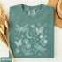 Comfort Colors garment-dyed t-shirt featuring a vintage botanical design with dragonflies, butterflies, bees, wildflowers, dandelions, floating seeds, hearts, stars, and a crescent moon.