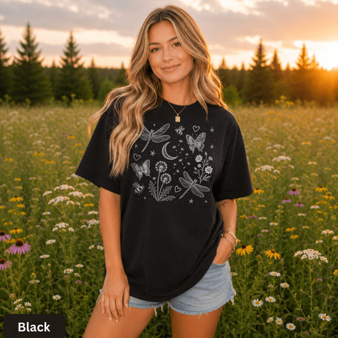 Comfort Colors garment-dyed t-shirt featuring a vintage botanical design with dragonflies, butterflies, bees, wildflowers, dandelions, floating seeds, hearts, stars, and a crescent moon.
