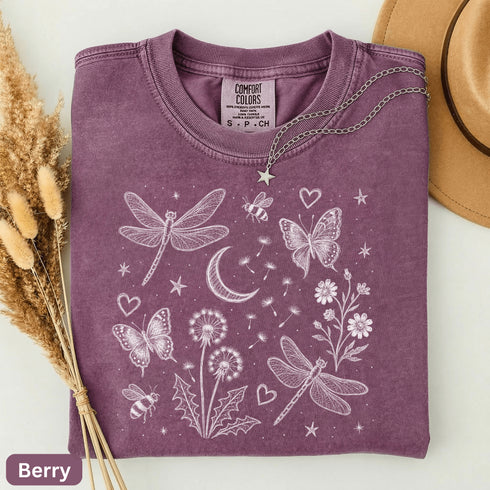 Comfort Colors garment-dyed t-shirt featuring a vintage botanical design with dragonflies, butterflies, bees, wildflowers, dandelions, floating seeds, hearts, stars, and a crescent moon.