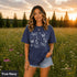 Comfort Colors garment-dyed t-shirt featuring a vintage botanical design with dragonflies, butterflies, bees, wildflowers, dandelions, floating seeds, hearts, stars, and a crescent moon.