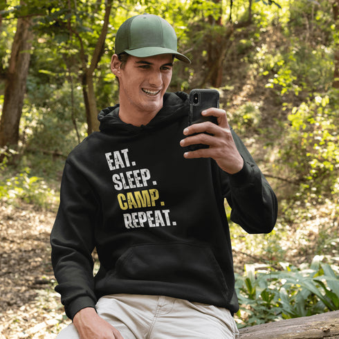 Introducing the ultimate camper's companion: the "Eat. Sleep. Camp. Repeat." Hoodie! This isn't just any ordinary piece of clothing. It's your best friend in the wilderness, your cozy confidante under the stars, and quite possibly the most honest representation of your weekend plans.