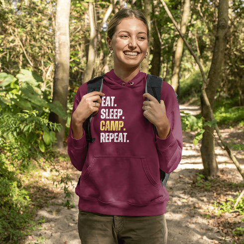 Introducing the ultimate camper's companion: the "Eat. Sleep. Camp. Repeat." Hoodie! This isn't just any ordinary piece of clothing. It's your best friend in the wilderness, your cozy confidante under the stars, and quite possibly the most honest representation of your weekend plans.