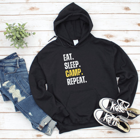 Introducing the ultimate camper's companion: the "Eat. Sleep. Camp. Repeat." Hoodie! This isn't just any ordinary piece of clothing. It's your best friend in the wilderness, your cozy confidante under the stars, and quite possibly the most honest representation of your weekend plans.
