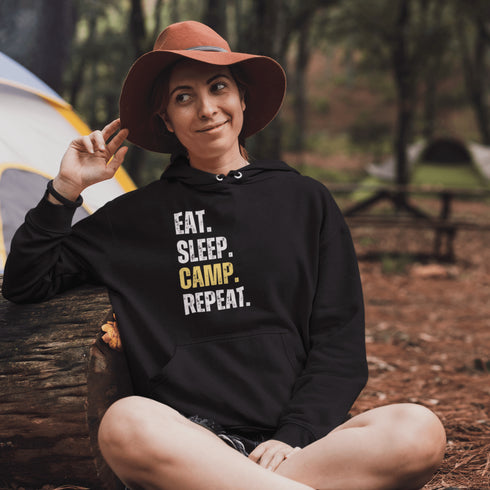 Introducing the ultimate camper's companion: the "Eat. Sleep. Camp. Repeat." Hoodie! This isn't just any ordinary piece of clothing. It's your best friend in the wilderness, your cozy confidante under the stars, and quite possibly the most honest representation of your weekend plans.