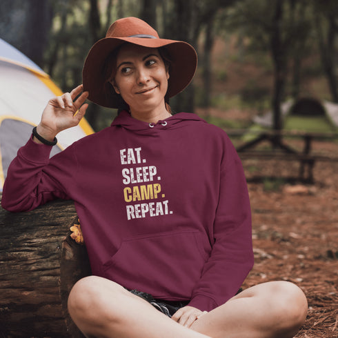 Introducing the ultimate camper's companion: the "Eat. Sleep. Camp. Repeat." Hoodie! This isn't just any ordinary piece of clothing. It's your best friend in the wilderness, your cozy confidante under the stars, and quite possibly the most honest representation of your weekend plans.