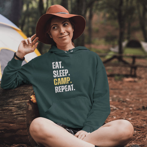 Introducing the ultimate camper's companion: the "Eat. Sleep. Camp. Repeat." Hoodie! This isn't just any ordinary piece of clothing. It's your best friend in the wilderness, your cozy confidante under the stars, and quite possibly the most honest representation of your weekend plans.