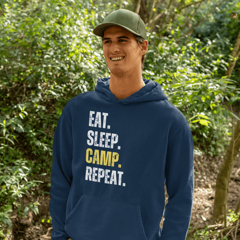 Introducing the ultimate camper's companion: the "Eat. Sleep. Camp. Repeat." Hoodie! This isn't just any ordinary piece of clothing. It's your best friend in the wilderness, your cozy confidante under the stars, and quite possibly the most honest representation of your weekend plans.