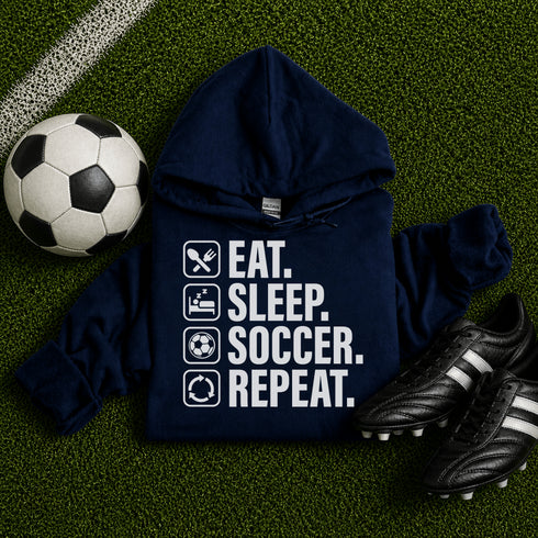 Navy blue “Eat Sleep Soccer Repeat” hoodie with white text and soccer icons, casual soccer apparel