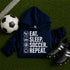 Navy blue “Eat Sleep Soccer Repeat” hoodie with white text and soccer icons, casual soccer apparel