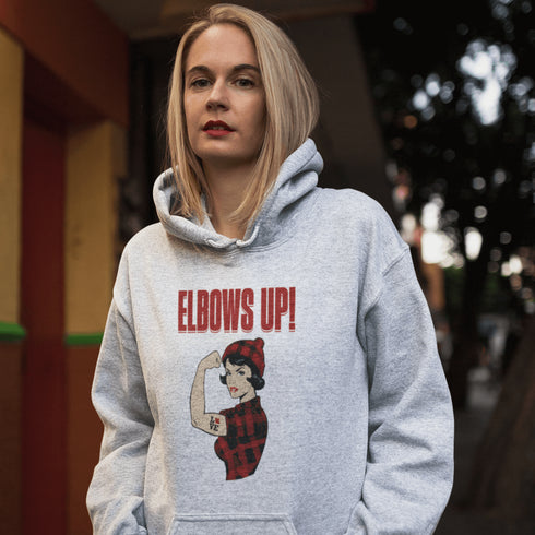 Meet the ultimate symbol of Canadian pride—a tough, toque-wearing, plaid-rocking legend flexing her muscle, because nothing says "I'm from the Great White North" like strength and style