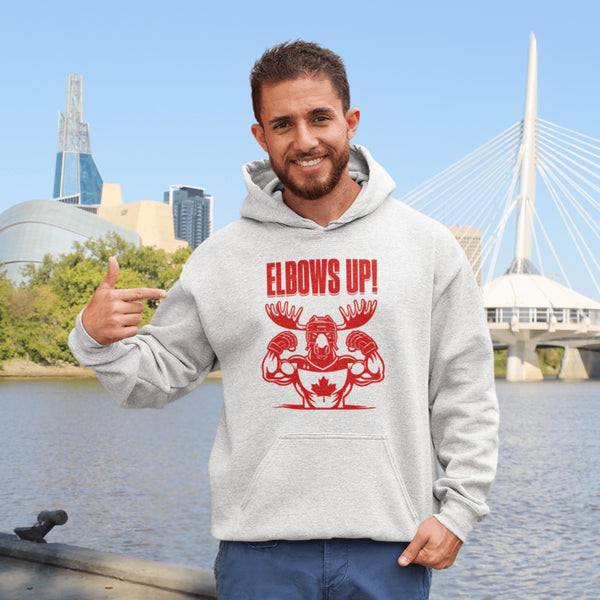 Get ready to hit the ice (or the couch) in style with our "Elbows Up!" hoodie! Featuring a tough-as-nails moose rocking a Canada hockey shirt and helmet while flexing its muscles
