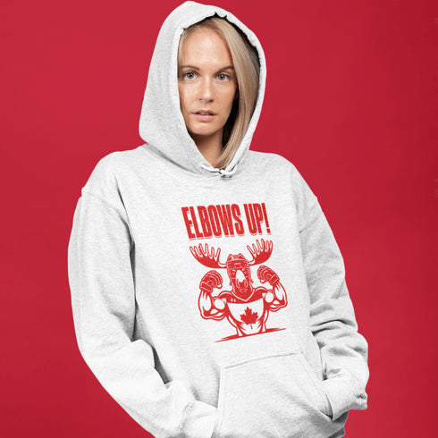 Get ready to hit the ice (or the couch) in style with our "Elbows Up!" hoodie! Featuring a tough-as-nails moose rocking a Canada hockey shirt and helmet while flexing its muscles