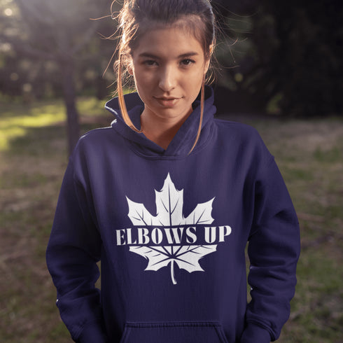 Featuring a bold maple leaf and the iconic "Elbows Up" phrase, this hoodie lets everyone know you’re not afraid to play hard—on the ice, in life