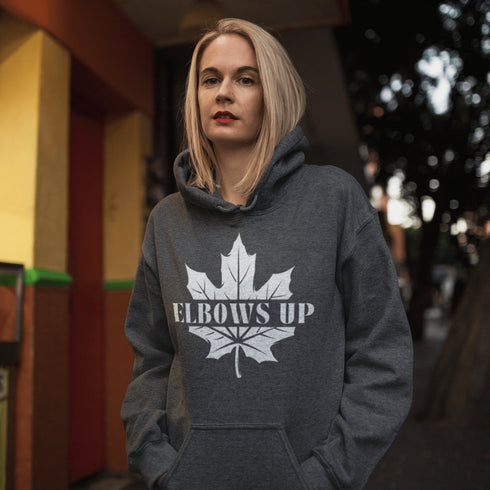 Featuring a bold maple leaf and the iconic "Elbows Up" phrase, this hoodie lets everyone know you’re not afraid to play hard—on the ice, in life