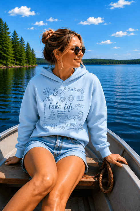 Customizable Lake Life hoodie featuring lake-themed illustrations including a dock, canoe, sailboat, campfire, fishing gear, and personalized lake name design on a unisex Gildan 18500 hoodie available in multiple colors.