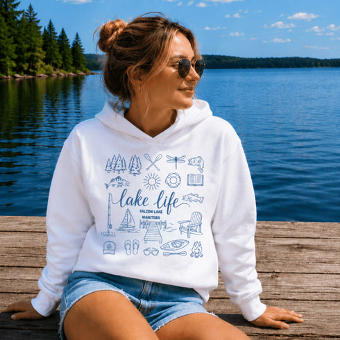 Customizable Lake Life hoodie featuring lake-themed illustrations including a dock, canoe, sailboat, campfire, fishing gear, and personalized lake name design on a unisex Gildan 18500 hoodie available in multiple colors.