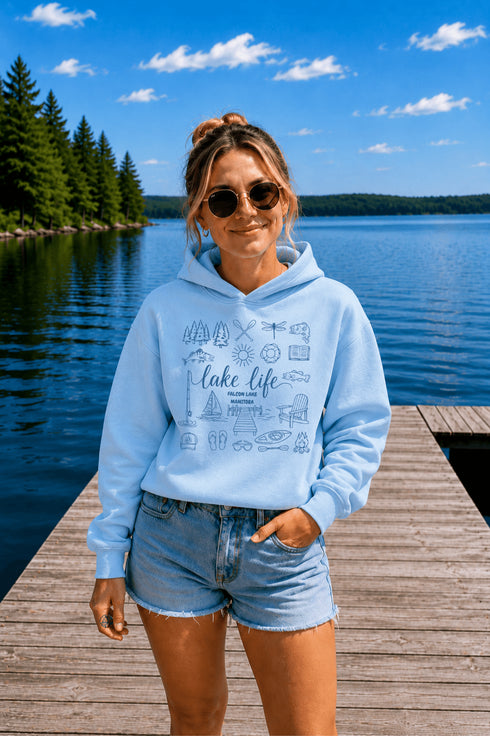 Customizable Lake Life hoodie featuring lake-themed illustrations including a dock, canoe, sailboat, campfire, fishing gear, and personalized lake name design on a unisex Gildan 18500 hoodie available in multiple colors.
