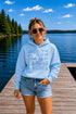Customizable Lake Life hoodie featuring lake-themed illustrations including a dock, canoe, sailboat, campfire, fishing gear, and personalized lake name design on a unisex Gildan 18500 hoodie available in multiple colors.