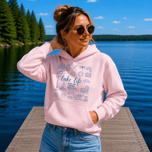Customizable Lake Life hoodie featuring lake-themed illustrations including a dock, canoe, sailboat, campfire, fishing gear, and personalized lake name design on a unisex Gildan 18500 hoodie available in multiple colors.