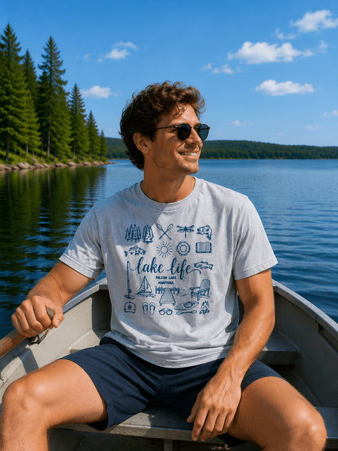 Man in a boat on a lake wearing a 'Lake Life' t-shirt with sunglasses.