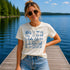 Woman wearing a 'lake life' t-shirt on a dock by a lake