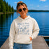 Customizable Lake Life hoodie featuring lake-themed illustrations including a dock, canoe, sailboat, campfire, fishing gear, and personalized lake name design on a unisex Gildan 18500 hoodie available in multiple colors.