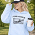 woman wearing grey hoodie with “Fear The Goalie” soccer goalkeeper design featuring diving goalie making a save