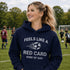 Woman wearing “Feels Like a Red Card Kind of Day” hoodie holding a soccer ball on a soccer field during a game