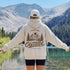Vintage outdoor graphic hoodie featuring a small left chest design and a large mountain landscape graphic on the back, available in multiple colors and shown in various lifestyle and product mockups.